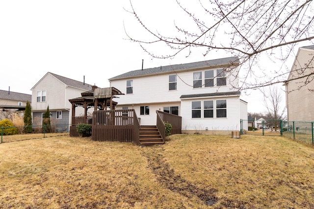 back of property with a yard, a fenced backyard, and a wooden deck