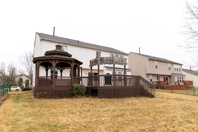 back of house featuring a gazebo, fence, a wooden deck, and a yard