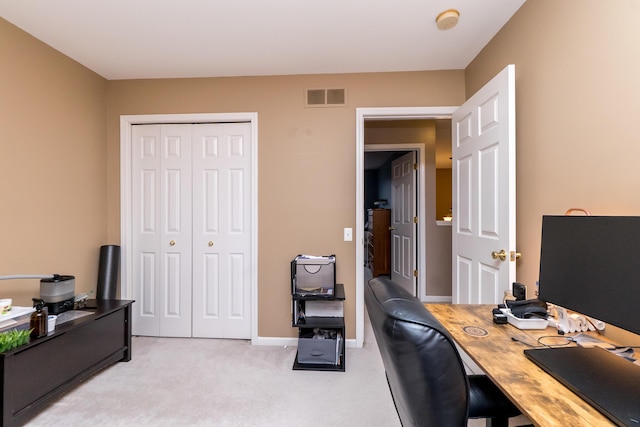 home office with baseboards, visible vents, and light colored carpet