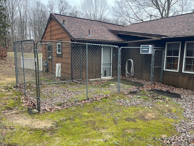 2539 W Giles Rd, Muskegon, MI 49445 - rear view of house featuring a shingled roof, fence, and a gate