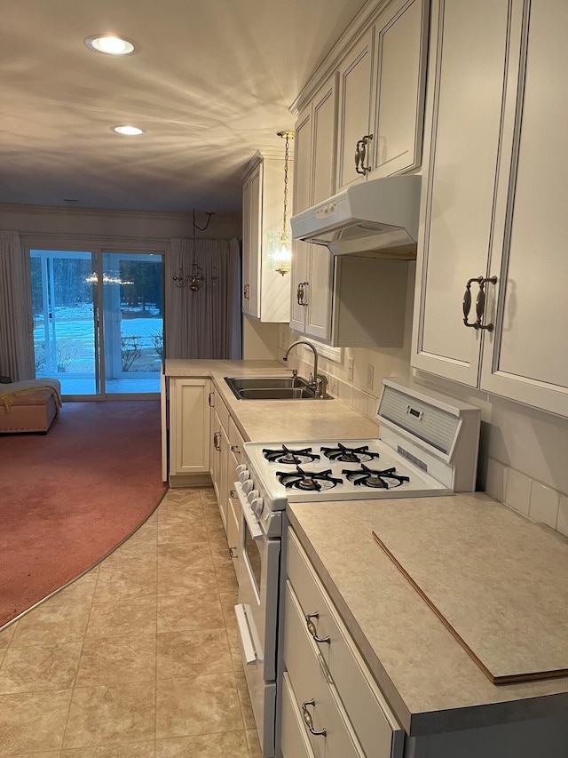 2539 W Giles Rd, Muskegon, MI 49445 - kitchen featuring gas range gas stove, a sink, under cabinet range hood, light countertops, and recessed lighting
