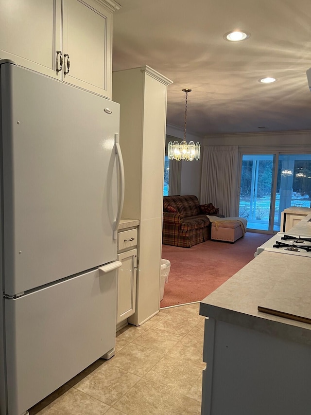 2539 W Giles Rd, Muskegon, MI 49445 - kitchen featuring freestanding refrigerator, recessed lighting, light colored carpet, white cabinets, and light tile patterned floors