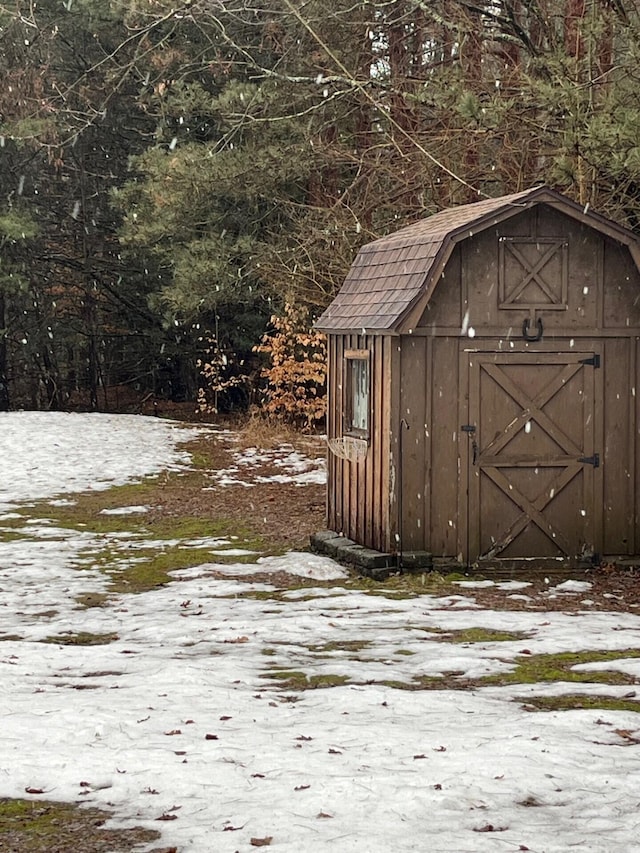 2539 W Giles Rd, Muskegon, MI 49445 - snow covered structure with a storage unit and an outbuilding