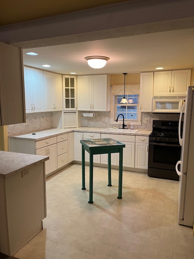 2539 W Giles Rd, Muskegon, MI 49445 - kitchen with white appliances, a sink, backsplash, light countertops, and recessed lighting