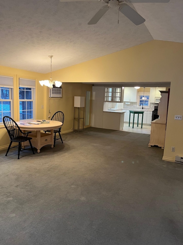 2539 W Giles Rd, Muskegon, MI 49445 - dining area with vaulted ceiling, a wall unit AC, baseboards, a ceiling fan, and dark carpet