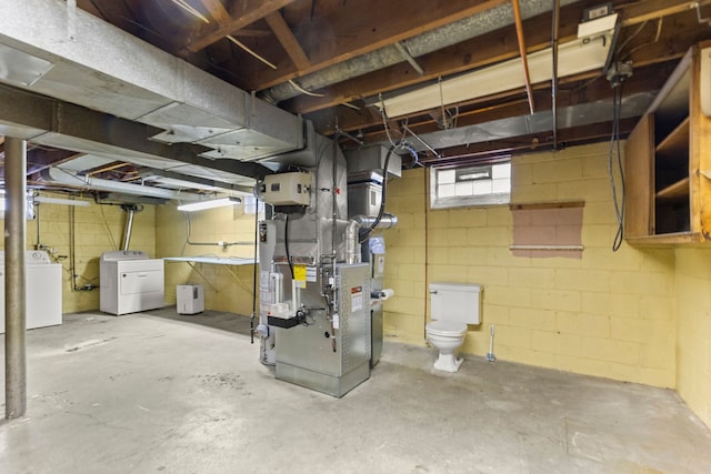 basement featuring separate washer and dryer and heating unit