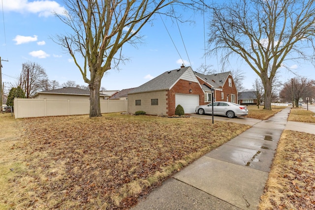 view of home's exterior featuring a garage, brick siding, and fence