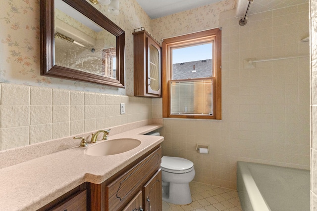 full bath with toilet, wallpapered walls, tile walls, and wainscoting