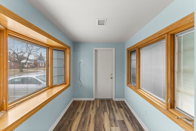 interior space with dark wood-style floors and baseboards