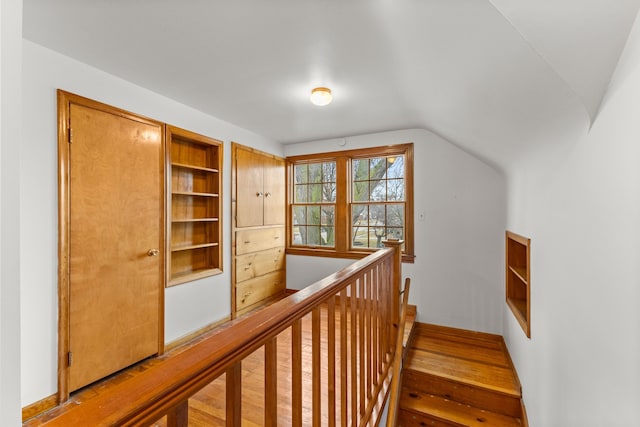 stairway with vaulted ceiling and wood finished floors