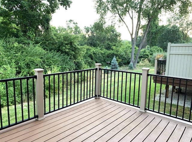 wooden deck featuring a yard