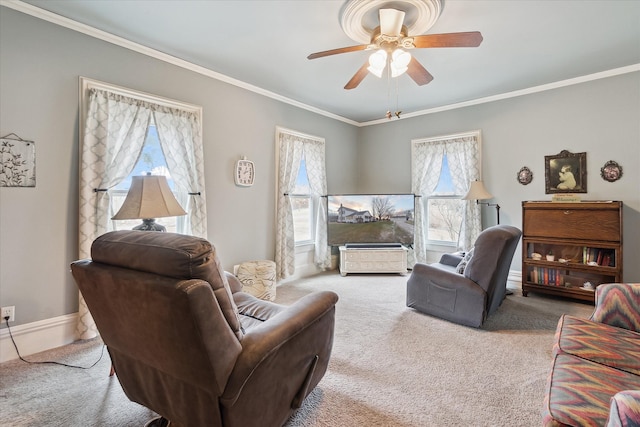 living room featuring baseboards, ceiling fan, carpet flooring, and crown molding