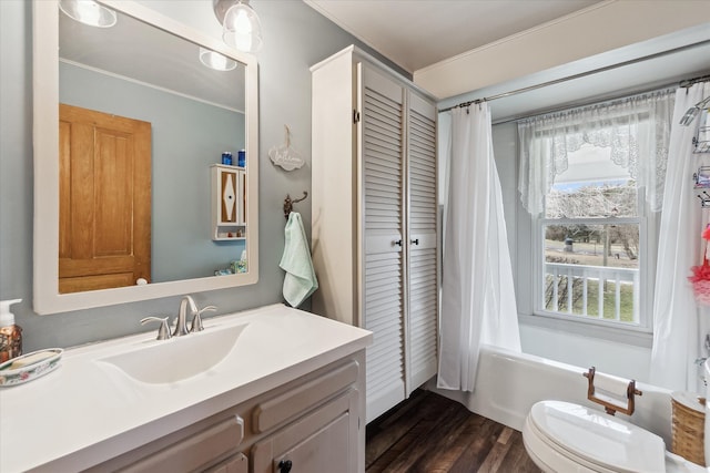 full bathroom with vanity, wood finished floors, toilet, and shower / tub combo with curtain