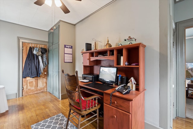 office space featuring light wood finished floors, ceiling fan, and crown molding