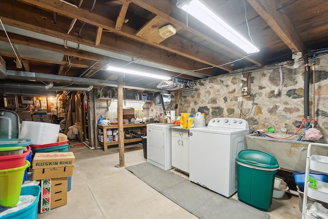 unfinished below grade area featuring washing machine and clothes dryer