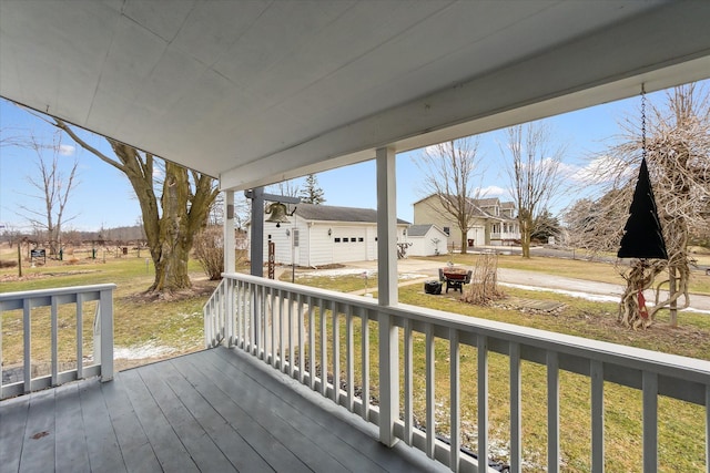 wooden deck with an outdoor structure and a lawn