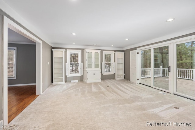 unfurnished bedroom featuring carpet, ornamental molding, recessed lighting, and access to exterior