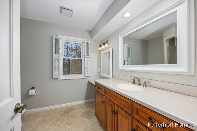 bathroom with visible vents, baseboards, and vanity