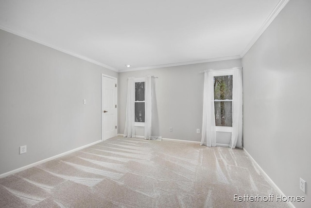 carpeted empty room featuring ornamental molding and baseboards