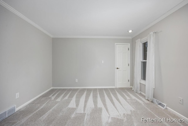 carpeted empty room featuring ornamental molding, visible vents, and baseboards