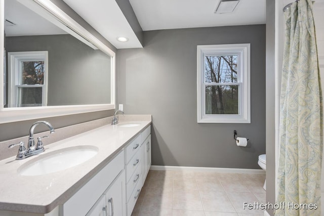 full bathroom featuring baseboards, a sink, toilet, and tile patterned floors