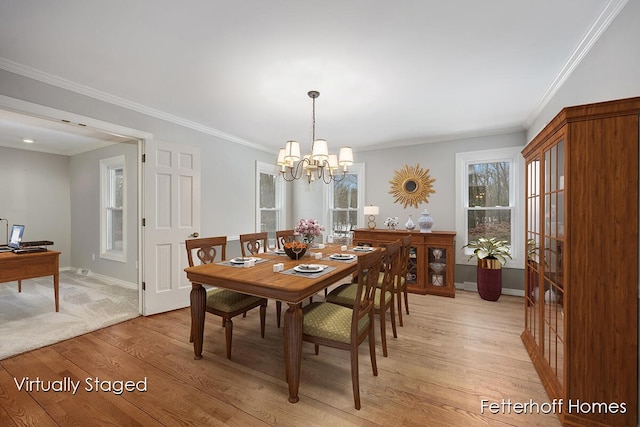 dining space with a notable chandelier, crown molding, baseboards, and light wood-style floors