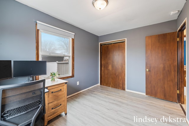 office with light wood-style flooring and baseboards