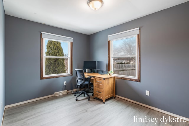 office space with light wood finished floors and baseboards