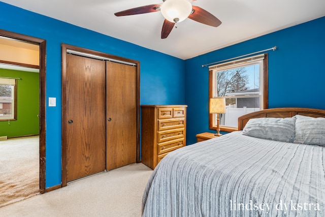 bedroom with carpet, ceiling fan, and a closet