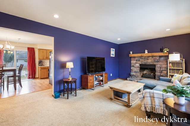 living room with recessed lighting, a fireplace, a chandelier, and light colored carpet