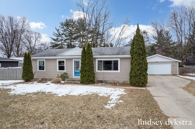 ranch-style home with an outbuilding, roof with shingles, fence, and a garage