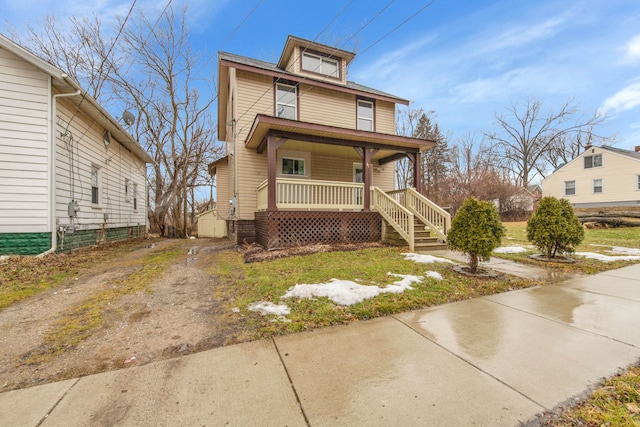 american foursquare style home with driveway and a porch