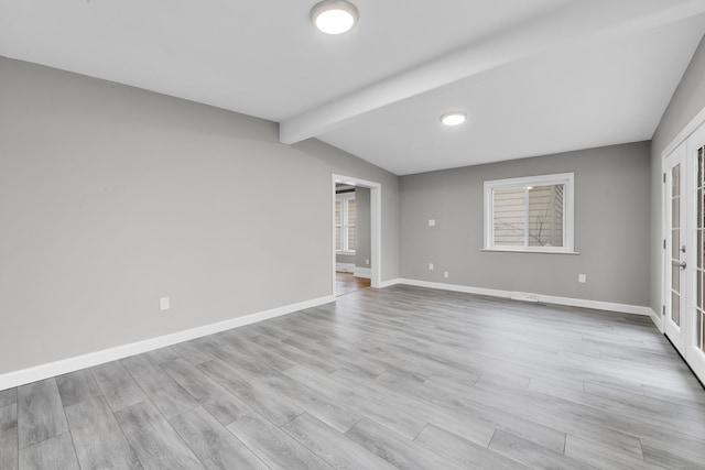 empty room with vaulted ceiling with beams, french doors, wood finished floors, and baseboards