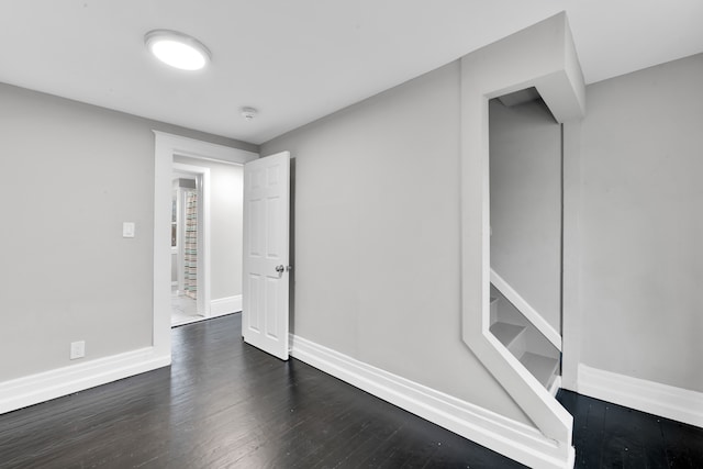 interior space with dark wood-style floors and baseboards