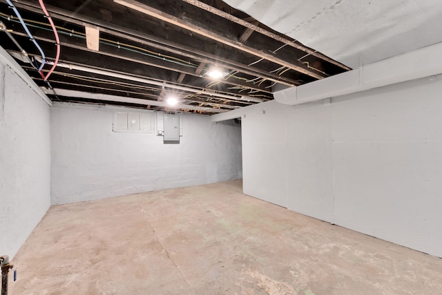 unfinished basement featuring electric panel