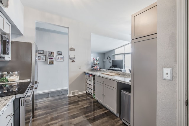 kitchen featuring baseboards, electric stove, dark wood-style floors, light stone countertops, and gray cabinets