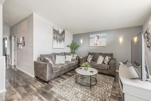 living area with wood finished floors and baseboards