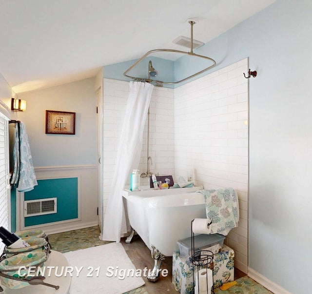 bathroom featuring visible vents, vaulted ceiling, a shower with shower curtain, and a bath