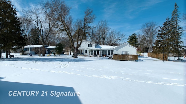 yard covered in snow with a deck