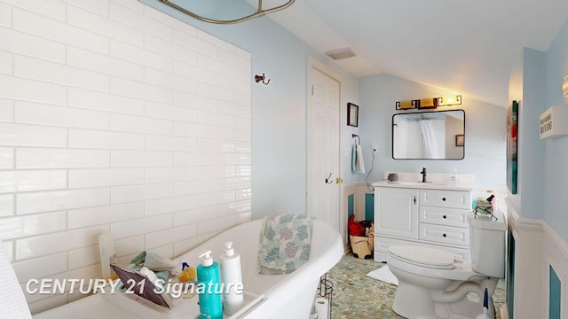 bathroom with visible vents, a freestanding bath, toilet, vaulted ceiling, and vanity