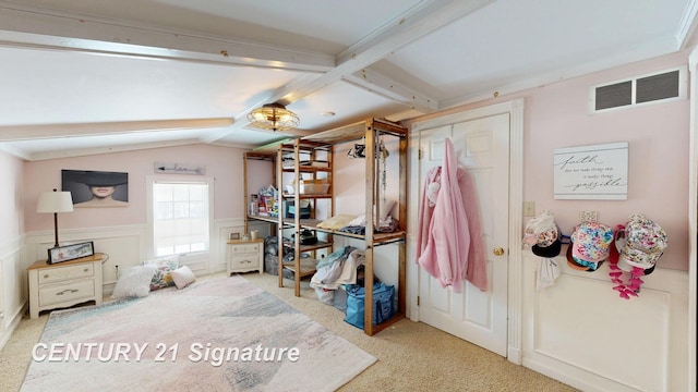 miscellaneous room with light colored carpet, wainscoting, visible vents, and lofted ceiling with beams