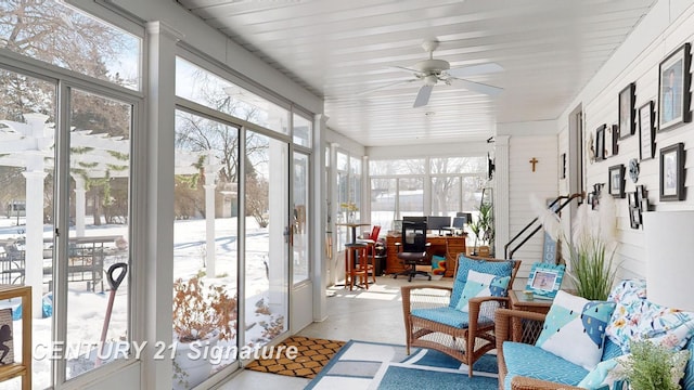 sunroom / solarium featuring plenty of natural light and a ceiling fan