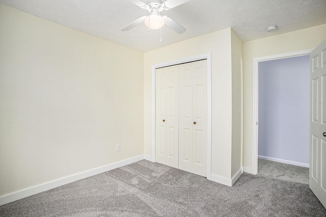 unfurnished bedroom featuring carpet, a textured ceiling, baseboards, and a closet