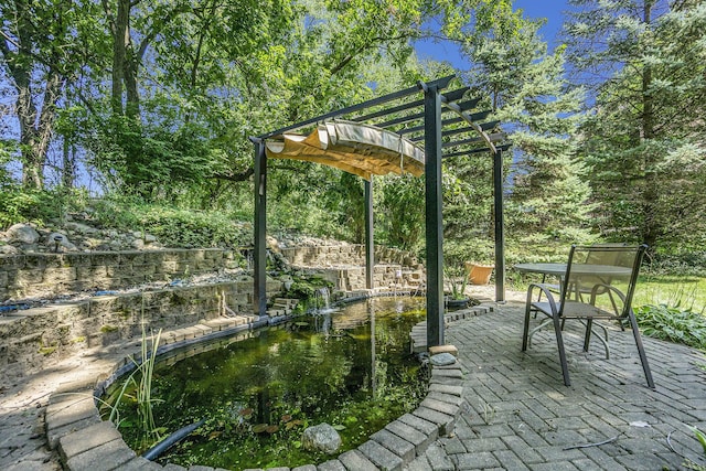 view of home's community with outdoor dining area, a pergola, and a patio