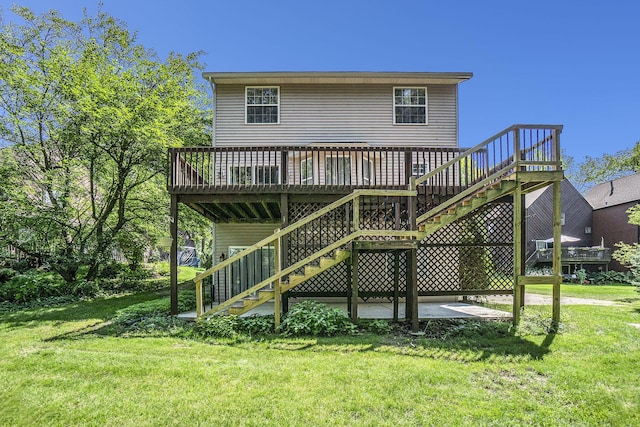 rear view of house featuring a yard, stairway, and a wooden deck