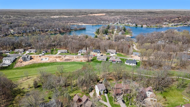 aerial view with a forest view and a water view