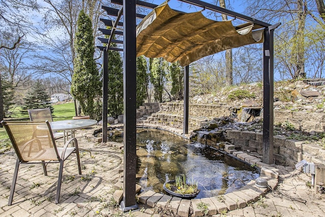 exterior space with outdoor dining area, a patio area, a garden pond, and a pergola