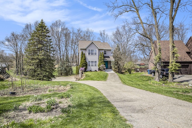 view of front facade featuring aphalt driveway and a front lawn