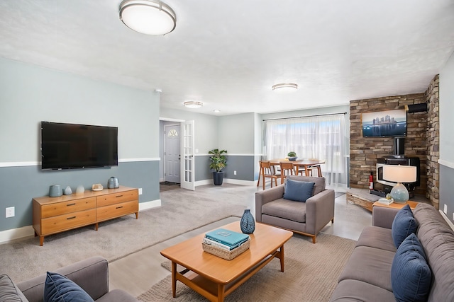 living area with a wood stove and baseboards