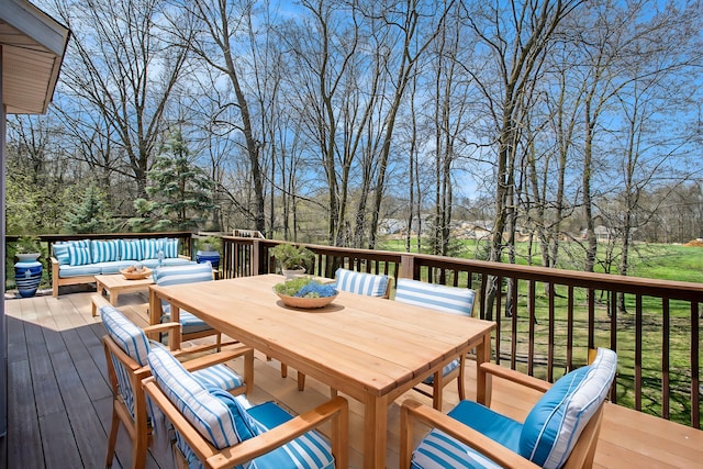 wooden deck with outdoor dining area and outdoor lounge area